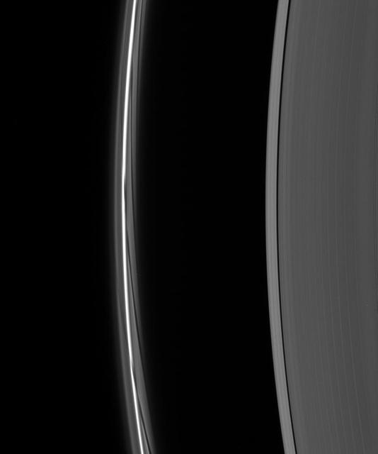 A close-up of the F ring shows dark gores in its interior faint ringlets following the passage of Prometheus. Each gore represents a single interaction of the moon with the F ring material