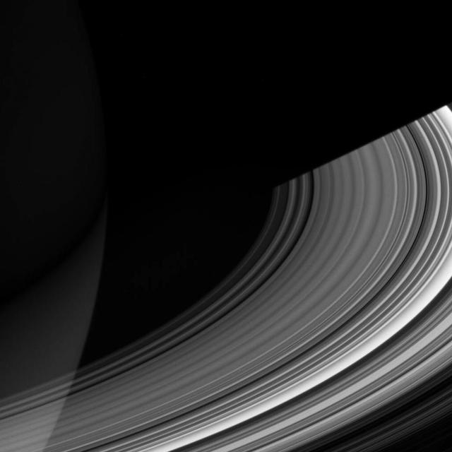 Both luminous and translucent, the C ring sweeps out of the darkness of Saturn's shadow and obscures the planet at lower left. The ring is characterized by broad, isolated bright areas, or "plateaus," surrounded by fainter material.  This view looks toward the unlit side of the rings from about 19 degrees above the ringplane. North on Saturn is up. The dark, inner B ring is seen at lower right.  The image was taken in visible light with the Cassini spacecraft wide-angle camera on Dec. 15, 2006 at a distance of approximately 632,000 kilometers (393,000 miles) from Saturn and at a Sun-Saturn-spacecraft, or phase, angle of 56 degrees. Image scale is 34 kilometers (21 miles) per pixel. http://photojournal.jpl.nasa.gov/catalog/PIA08855