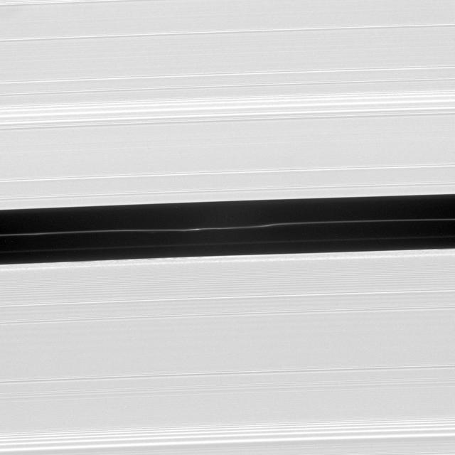 Bright undulations disturb a faint ringlet drifting through the center of the Encke Gap. This ring structure shares the orbit of the moon Pan