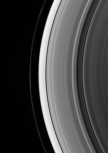 Epimetheus is a lonely dot beyond Saturn rings. The little moon appears at lower left, outside the narrow F ring. Several very faint spokes lurk in the B ring, at right