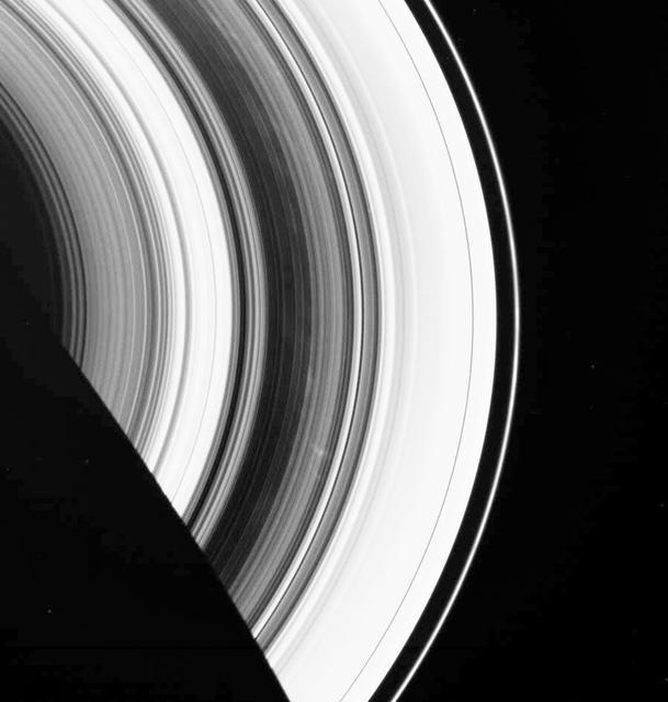 The dark B ring of Saturn is highlighted here by numerous faint spokes. The two most prominent spokes are seen below and to the right of center