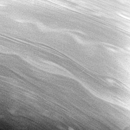 The smooth, linear contours and long, gently meandering character of the clouds in this view suggest stable prevailing winds at these latitudes, from 57 to 67 degrees north on Saturn