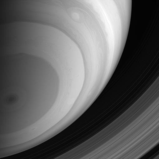 The Cassini spacecraft captures a spectacular view of Saturn banded southern hemisphere and dark central polar storm, while its dazzling rings lie far beyond the horizon