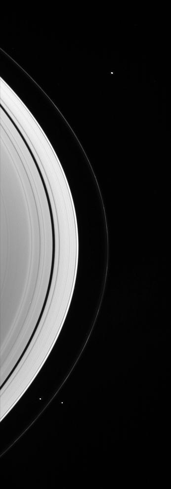 Three of the small worlds that hug the outer edges of Saturn immense ring system are captured in this Cassini spacecraft portrait
