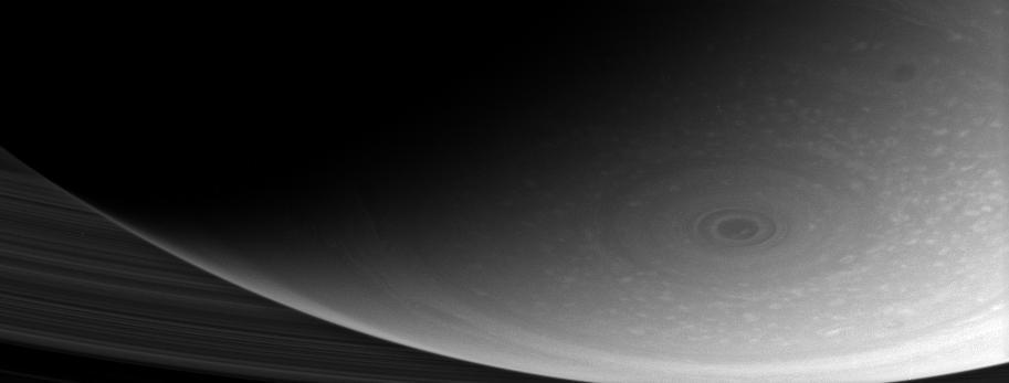 This dramatic close-up of Saturn south pole shows the hurricane-like vortex that resides there. The entire polar region is dotted with bright clouds, including one that appears to be inside the central ring of the polar storm