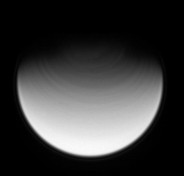 The rapidly rotating clouds above Titan northernmost latitudes stretch into streaks that circumscribe the pole. The ultraviolet spectral filter used to take this image allows the Cassini spacecraft to view the moon stratosphere