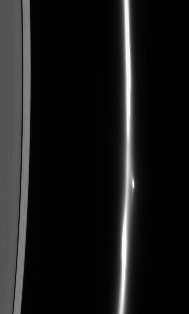The F ring dissolves into a fuzzy stream of particles -- rather different from its usual appearance of a narrow, bright core flanked by dimmer ringlets. Also notable here is the bright clump of material that flanks the ring core