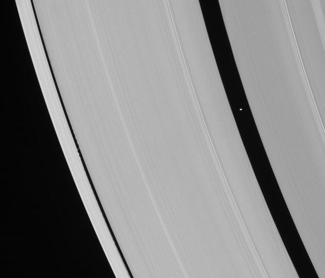 Saturn ring-embedded moons, Pan and Daphnis, are captured in an alignment they repeat with the regularity of a precise cosmic clock