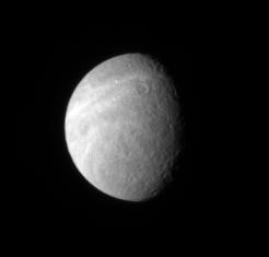 Wispy markings reach out across Rhea surface from its trailing hemisphere. The bright markings appear to be fractures, like those found on Dione