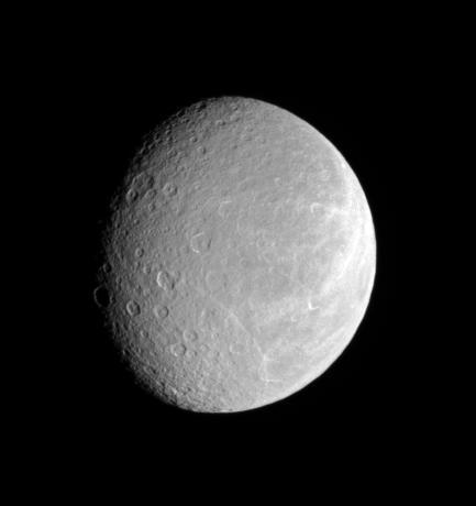 After nearly three years at Saturn, the Cassini spacecraft continues to observe the planet retinue of icy moons. Rhea cratered face attests to its great age, while its bright wisps hint at tectonic activity in the past