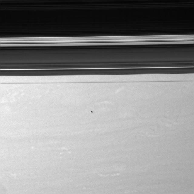 Epimetheus floats above Saturn swirling skies