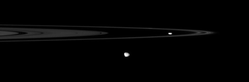 The Cassini spacecraft spies two of the small, irregular moons that patrol the outer edges of Saturn main rings