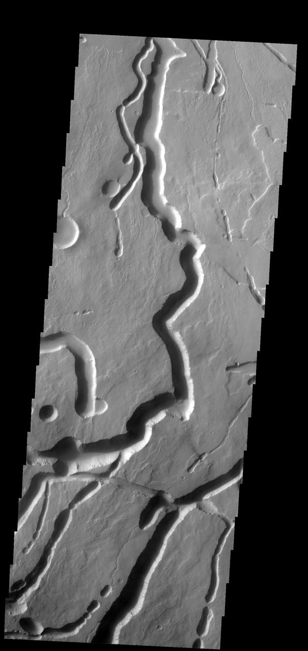 These channels and channel-like collapse features are located on the northeastern flank of Ascraeus Mons