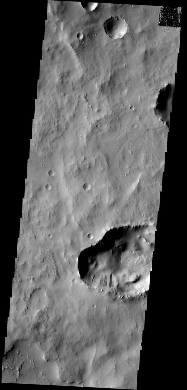 This depression within Cassini Crater contains several slope streaks. The darkest streaks are assumed to be younger than the lighter streaks