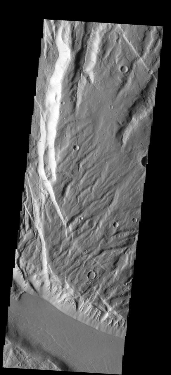This faulted and eroded surface is part of Acheron Fossae
