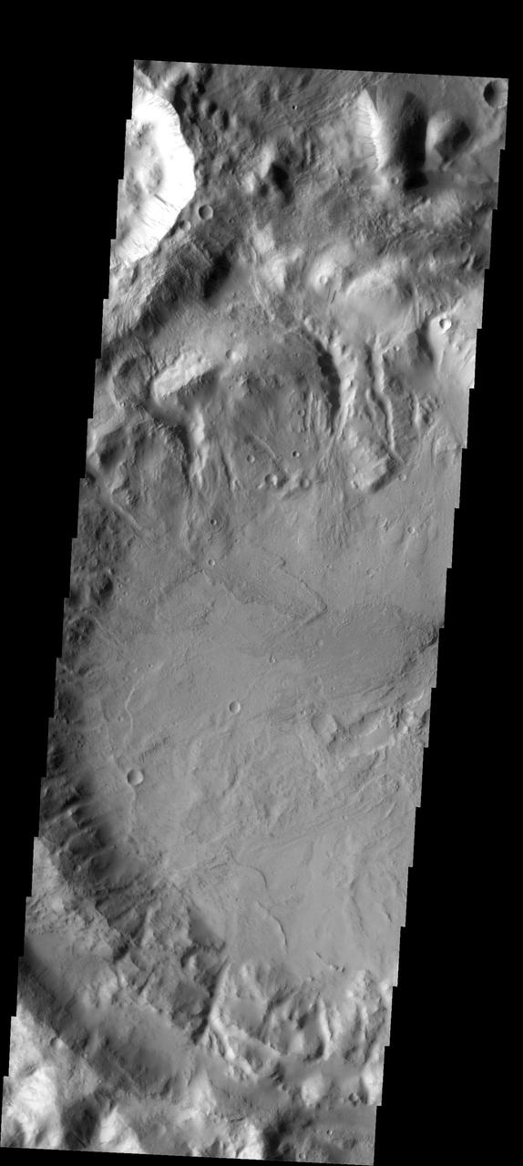 This image shows slope streaks on a small hill. The hill is near an unnamed crater at the south end of Phlegra Montes