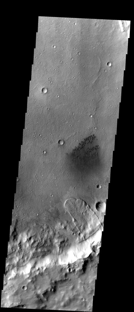 This unnamed crater east of Herschel Crater contains both a large landslide and a field of small dark sand dunes