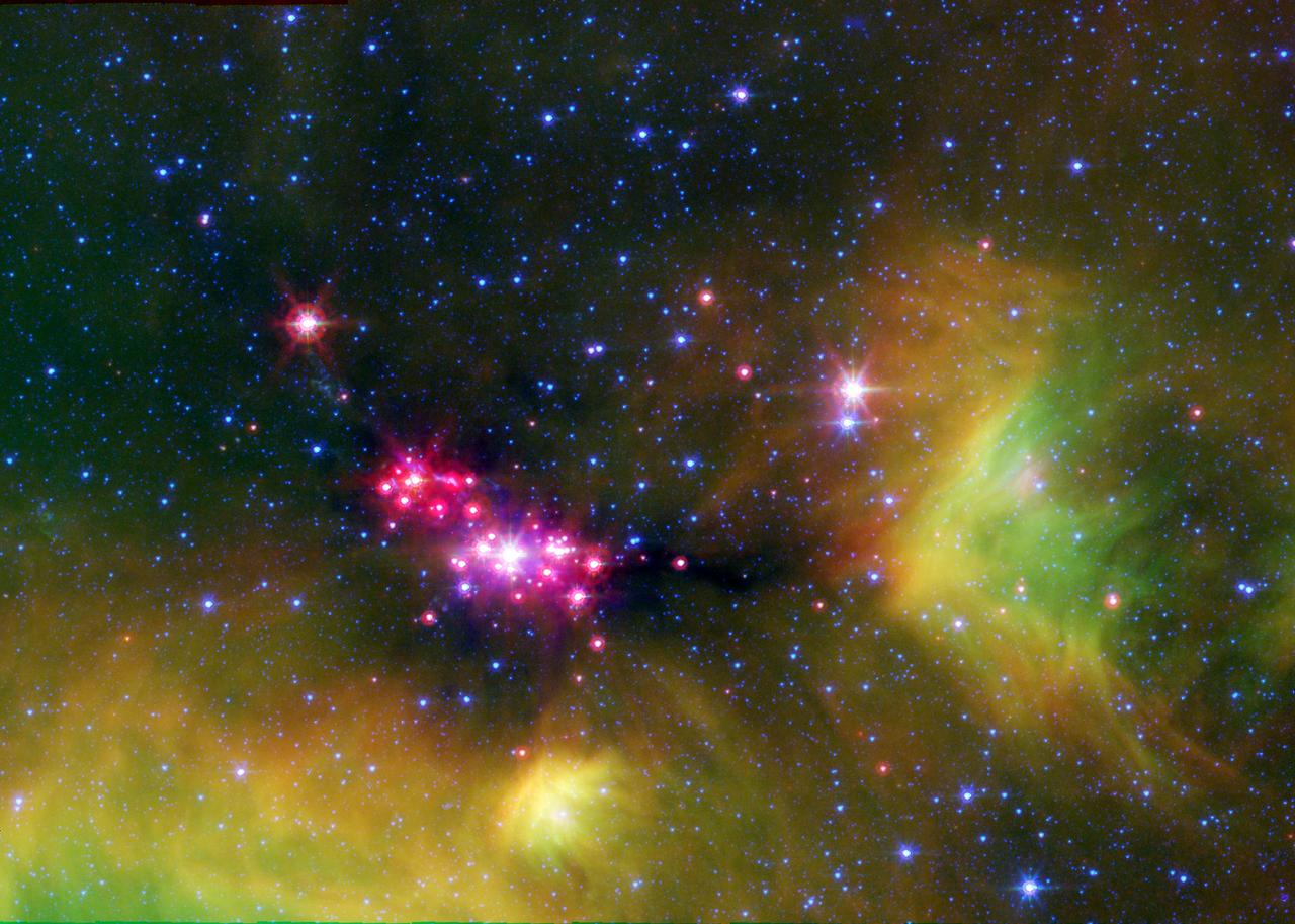 Infant stars are glowing gloriously in this image of the Serpens star-forming region, captured by NASA Spitzer Space Telescope. The reddish-pink dots are baby stars deeply embedded in the cosmic cloud of gas and dust that collapsed to create it.