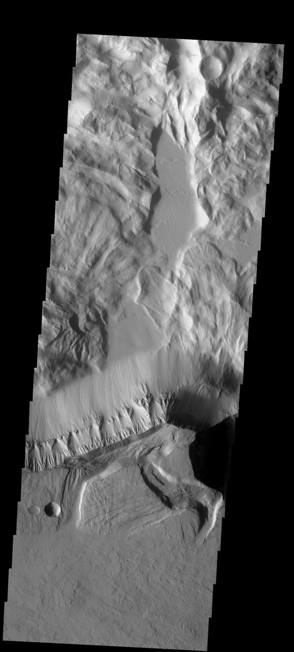 This spectacular image of the northern escarpment of Olympus Mons contains many different features. Lava flows are visible at the bottom of the frame