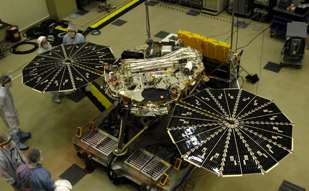 In this photograph of NASA Phoenix Mars Lander, the spacecraft specialists worked on the lander after its fan-like circular solar arrays had been spread open for testing. 