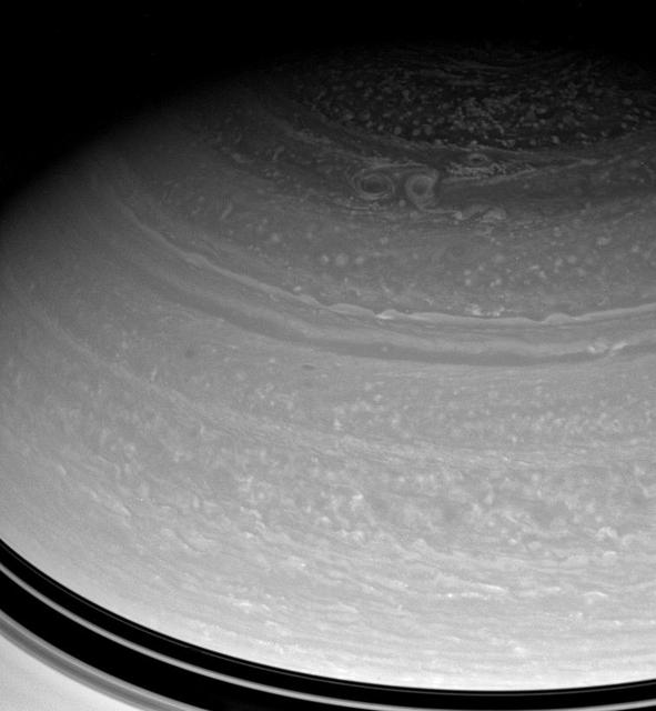 A trio of large storms embraces in Saturn high north. The three prominent vortices seen here are each wide enough to span the distance from New York City to Denver, or from London to Moscow