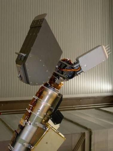 This four-spike tool, called the thermal and electrical conductivity probe, is in the middle-right of this photo, mounted near the end of the arm near NASA Phoenix Mars Lander scoop upper left.