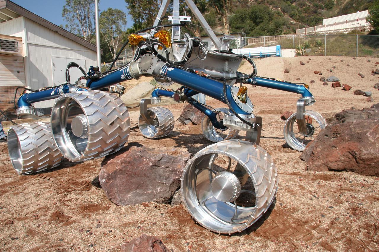 Scarecrow, a mobility-testing model for NASA Mars Science Laboratory, easily traverses large rocks in the Mars Yard testing area at NASA Jet Propulsion Laboratory.
