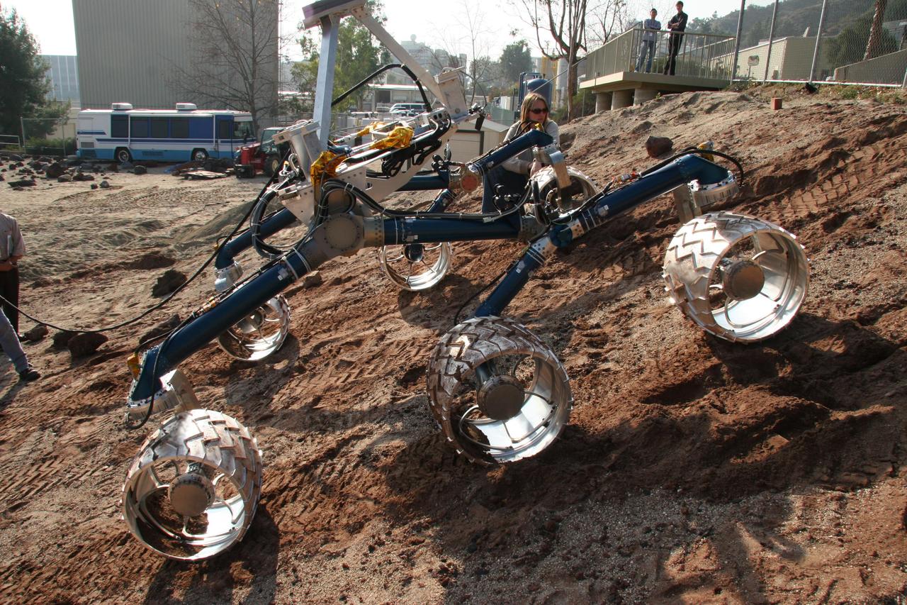 An engineering model for NASA Mars Science Laboratory makes its way up a hill in the Mars Yard testing area at NASA Jet Propulsion Laboratory.