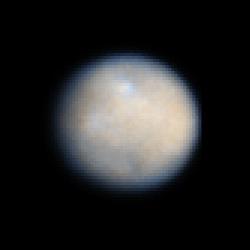 This is a NASA Hubble Space Telescope color image of dwarf planet Ceres, the largest object in the asteroid belt. The contrast has been enhanced to reveal surface details.