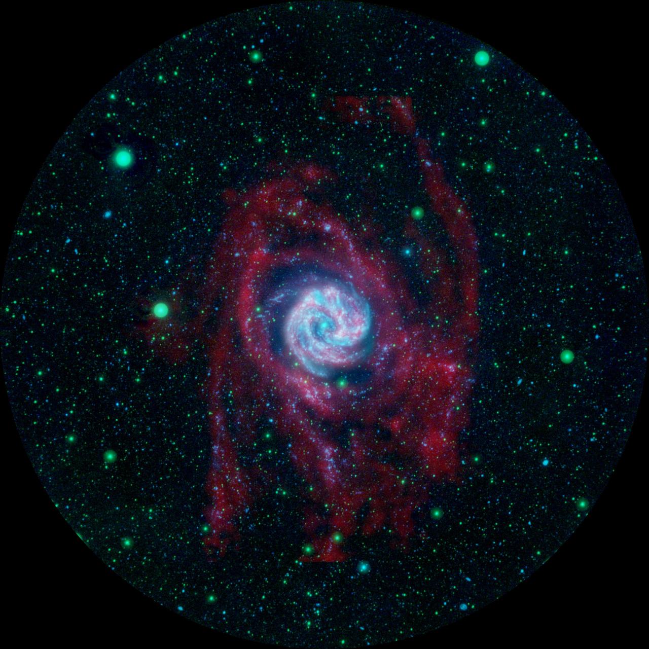 The outlying regions around the Southern Pinwheel galaxy, or M83, are highlighted in this composite image from NASA Galaxy Evolution Explorer and the National Science Foundation Very Large Array in New Mexico.