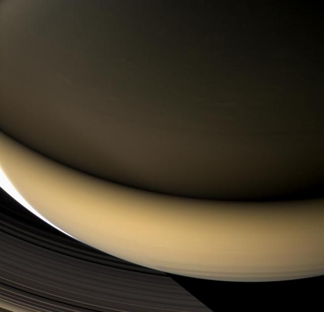 Large regions of Saturn night side are illuminated by the planet gleaming rings. Except for a sliver of the sunlit crescent at left, this view shows a part of the planet lit almost entirely by ringshine.