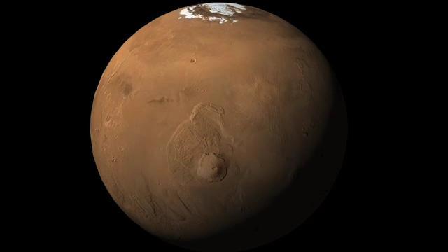 This image shows an orbital view sweeping upward from Olympus Mons, the tallest volcano in the solar system, to the location of NASA Phoenix Mars Lander in the northern polar reaches of Mars.
