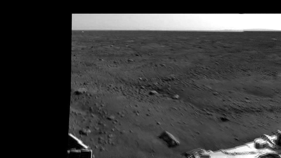 This image zooms in on the backshell and parachute, about 300 meters to the south of NASA Phoenix Mars Lander. In the distance, about 9 miles or 15 kilometers away, is a range of hills..