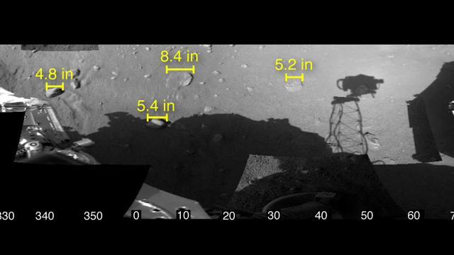 This image shows the workspace reachable by the scoop on the robotic arm of NASA Phoenix Mars Lander, along with some measurements of rock sizes.