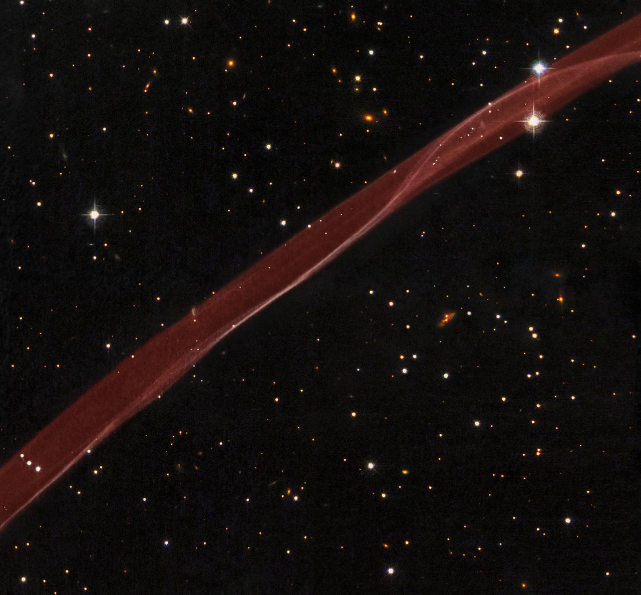 A delicate ribbon of gas floats eerily in our galaxy. This image, taken by NASA Hubble Space Telescope, is a very thin section of a supernova remnant caused by a stellar explosion that occurred more than 1,000 years ago.