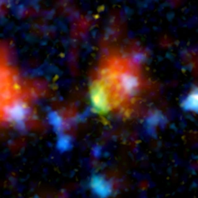 The green and red splotch in this image is the most active star-making galaxy in the very distant universe. Nicknamed Baby Boom, it was spotted 12.3 billion light-years away by a suite of telescopes, including NASA Spitzer Space Telescope. 