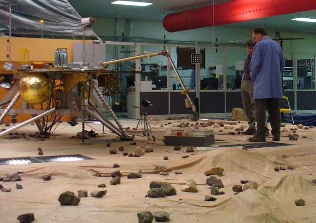 Members of NASA Phoenix Mars Mission Robotic Arm engineering team test the arm motorized rasp in the Payload Interoperability Testbed at the University of Arizona, Tucson.