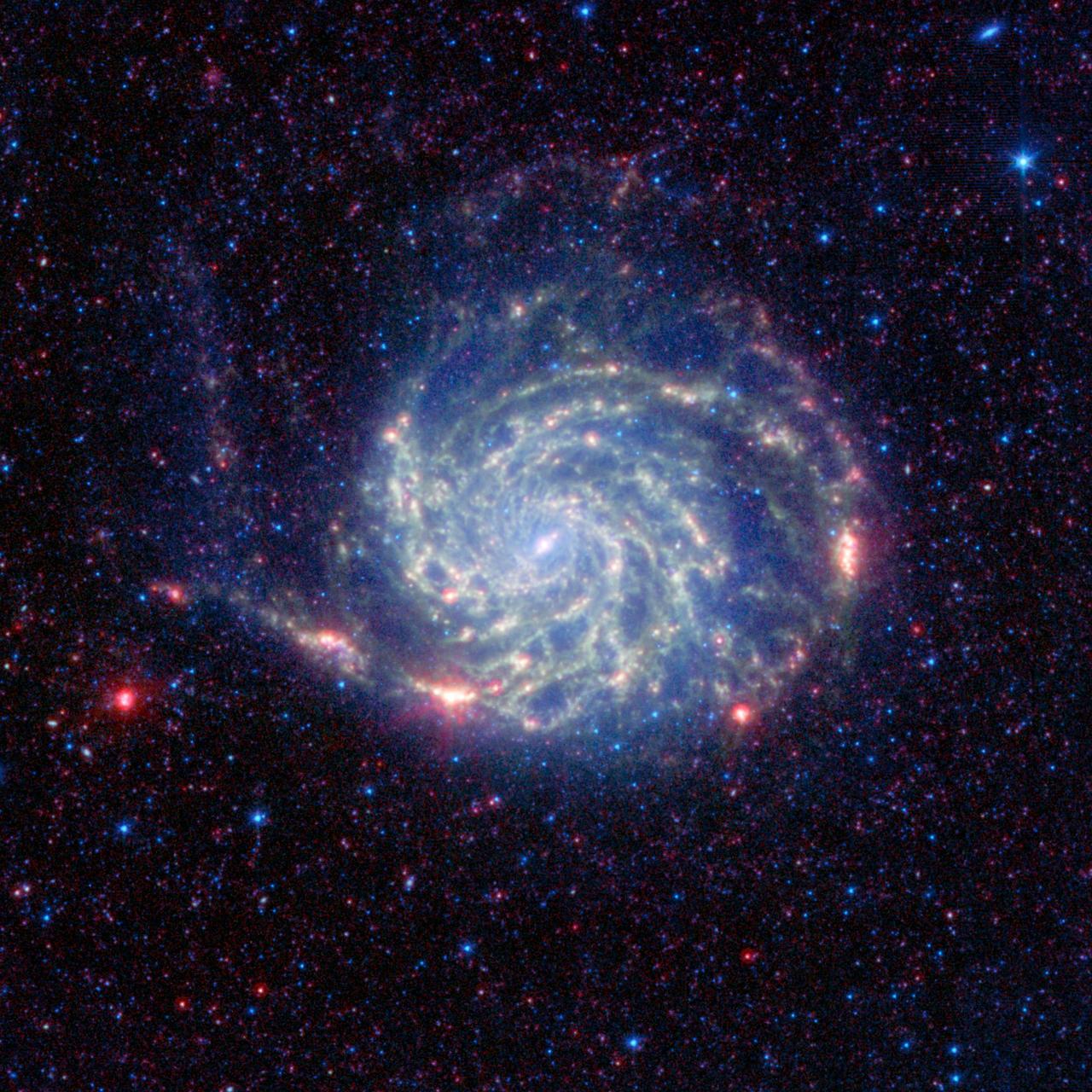 The Pinwheel galaxy, otherwise known as Messier 101, sports bright reddish edges in this new infrared image from NASA Spitzer Space Telescope.