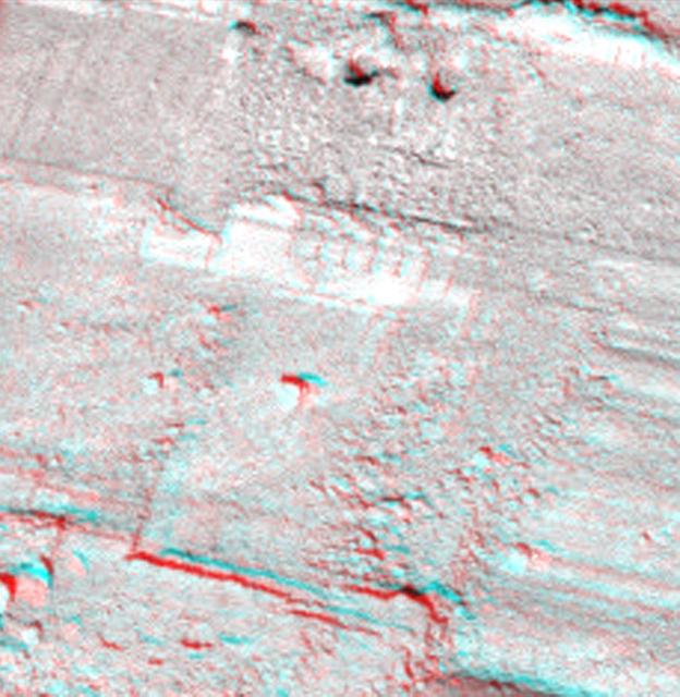 This view from NASA Phoenix Mars Lander shows a portion of the trench informally named Snow White, with two holes near the top of the image. 3D glasses are necessary to view this image.
