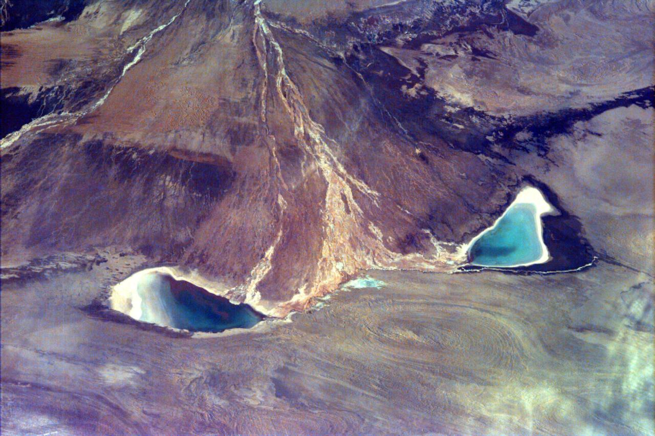 This image captures the beauty of a major alluvial fan in Tsinghai, a province located in Northwestern China. This archival image was taken from NASA Space Shuttle in 1997 as part of its ISS EarthKAM mission.