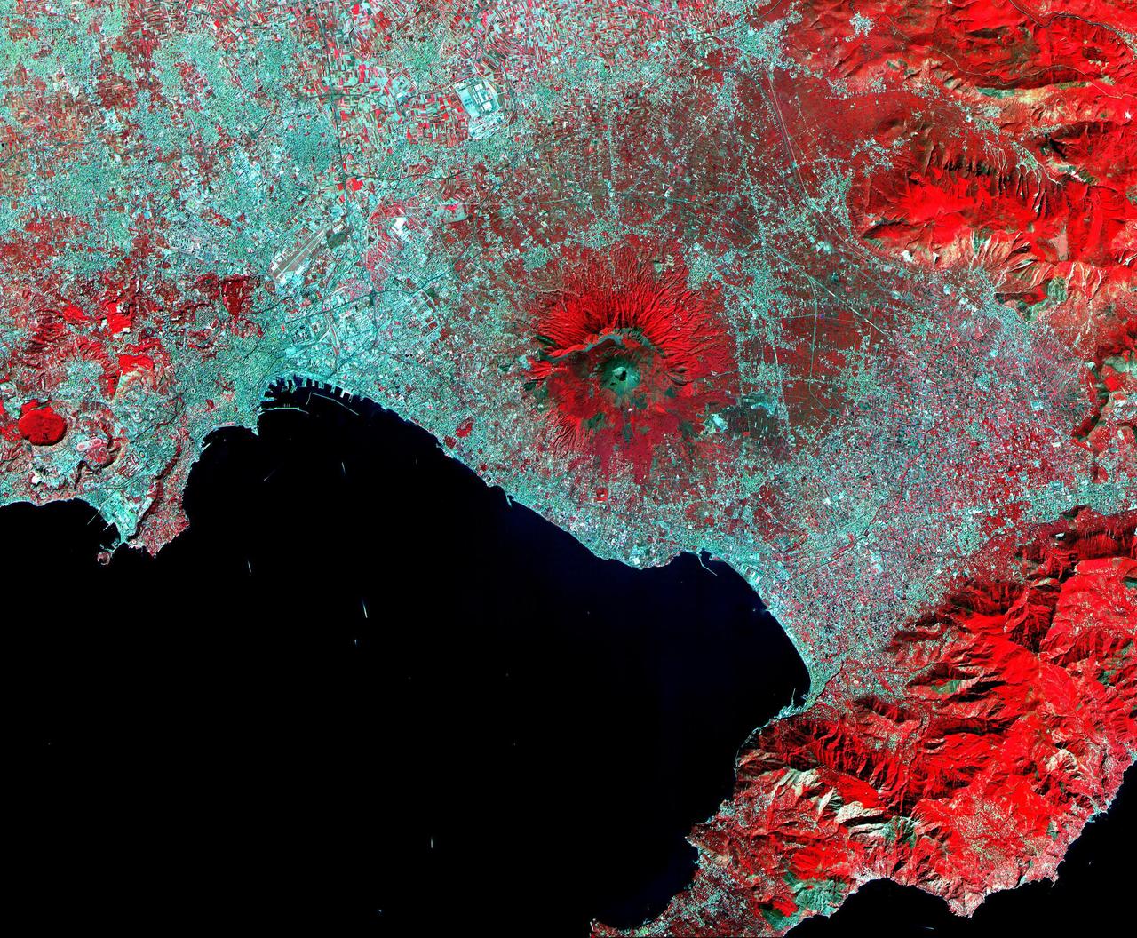 This ASTER image of Mt. Vesuvius Italy was acquired September 26, 2000, and covers an area of 36 by 45 km. Vesuvius overlooks the city of Naples and the Bay of Naples in central Italy. In 79 AD, Vesuvius erupted cataclysmically, burying all of the surrounding cites with up to 30 m of ash. The towns of Pompeii and Herculanaeum were rediscovered in the 18th century, and excavated in the 20th century. They provide a snapshot of Roman life from 2000 years ago: perfectly preserved are wooden objects, food items, and the casts of hundreds of victims. Vesuvius is intensively monitored for potential signs of unrest that could signal the beginning of another eruption. The image is centered at 40.8 degrees north latitude, 14.4 degrees east longitude. http://photojournal.jpl.nasa.gov/catalog/PIA11091