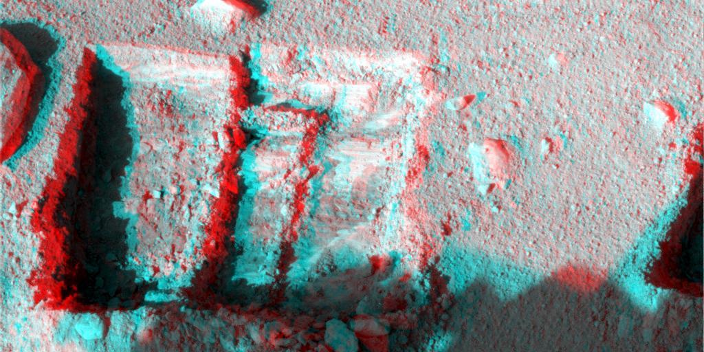 This anaglyph was taken by NASA Phoenix Mars Lander Surface Stereo Imager Oct. 7, 2008. The anaglyph highlights the depth of the trench, informally named La Mancha, and reveals the ice layer beneath the soil surface. 3D glasses are necessary.