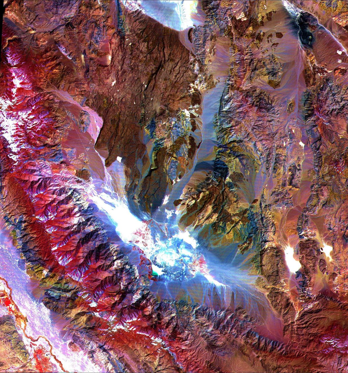 These images of the Saline Valley area, California, were acquired March 30, 2000 and cover a full ASTER scene (60 by 60 km). Each image displays data from a different spectral region, and illustrates the complementary nature of surface compositional information available as a function of wavelength. This image displays visible and near infrared bands 3, 2, and 1 in red, green, and blue (RGB). Vegetation appears red, snow and dry salt lakes are white, and exposed rocks are brown, gray, yellow and blue. Rock colors mainly reflect the presence of iron minerals, and variations in albedo. Figure 1 displays short wavelength infrared bands 4, 6, and 8 as RGB. In this wavelength region, clay, carbonate, and sulfate minerals have diagnostic absorption features, resulting in distinct colors on the image. For example, limestones are yellow-green, and purple areas are kaolinite-rich. Figure 2 displays thermal infrared bands 13, 12 and 10 as RGB. In this wavelength region, variations in quartz content appear as more or less red; carbonate rocks are green, and mafic volcanic rocks are purple. The image is located at 36.8 degrees north latitude and 117.7 degrees west longitude. http://photojournal.jpl.nasa.gov/catalog/PIA11164