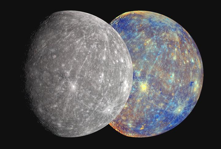 Two overlapping views of Mercury. The first, on the left side of the frame shows the planet – with two-thirds of its right side lit up by sunlight – in gray, with very slight color variations, including the occasional beige tint to the gray, and bright, silvery white rays spreading across the ground, emanating from about a half-dozen craters. It’s partially covering the other view of Mercury against the black backdrop of space, behind and to the right of the first planet image. This is similarly lit, its right side two-thirds bathed in sunlight, but the surface is a riot of colors – yellows and oranges capping the north and south poles, craters appearing as bright golden yellow accented in turquoise rings and lines, vivid navy and electric blue covering much of the planet’s upper left and lower right quadrants, while an underlying smear of mauve covers the lower left to upper right.