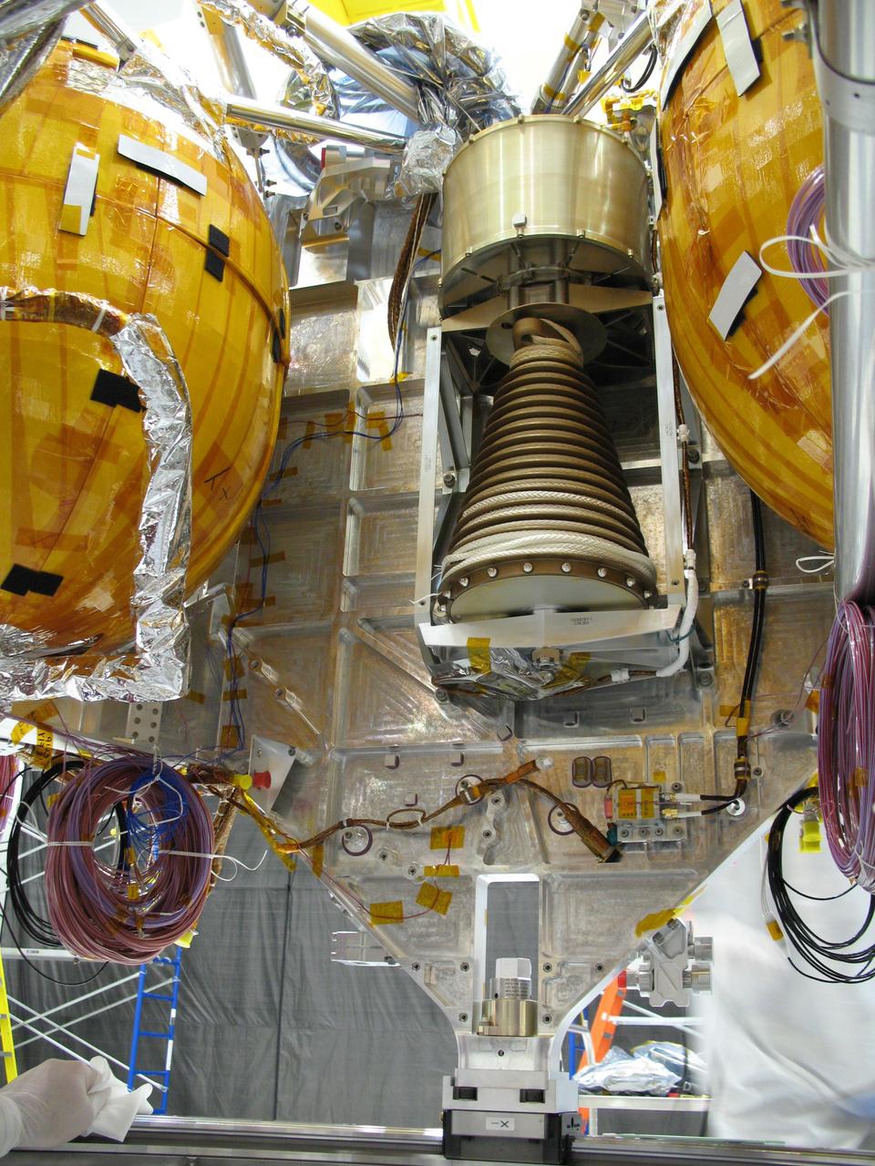 This view of a portion of the descent stage of NASA Mars Science Laboratory shows two of the stage three spherical fuel tanks flanking the bridle device assembly.