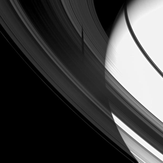 The shadow of the moon Tethys is revealed on Saturn B and C rings in this image which also includes the planet.