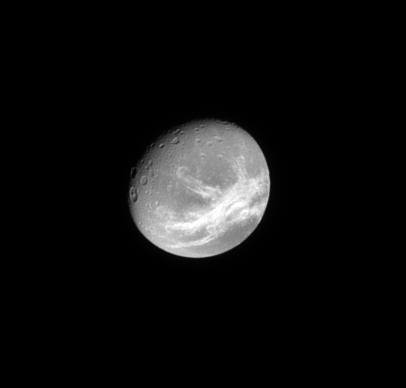 The Cassini spacecraft looks toward the wispy, fractured terrain of the trailing hemisphere of the moon Dione.