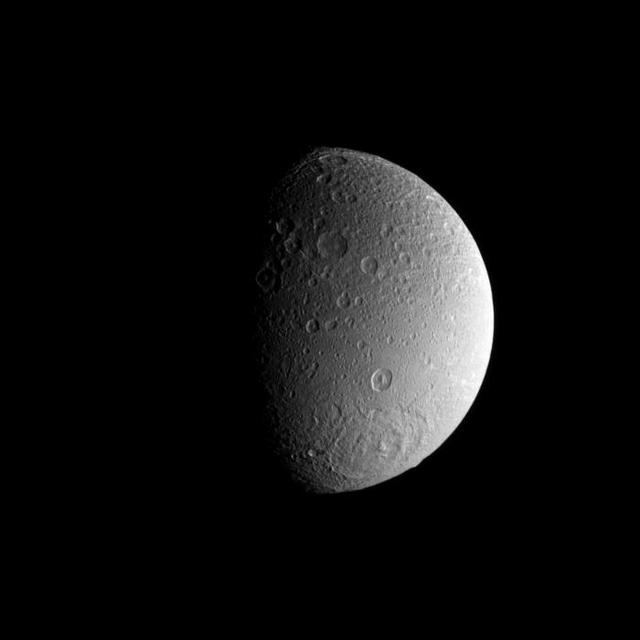A large impact basin dominates the high southern latitudes of Saturn moon Dione.