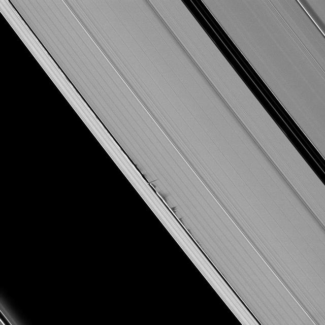 Jagged looking shadows stretch away from vertical structures of ring material created by the moon Daphnis in this image taken as Saturn approaches its August 2009 equinox.