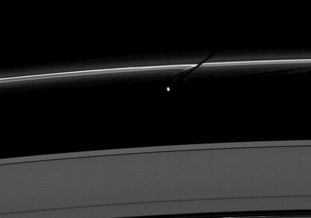 The moon Prometheus casts a shadow on the thin F ring marked with streamer-channels created by the moon in this image taken as Saturn approaches its August 2009 equinox.